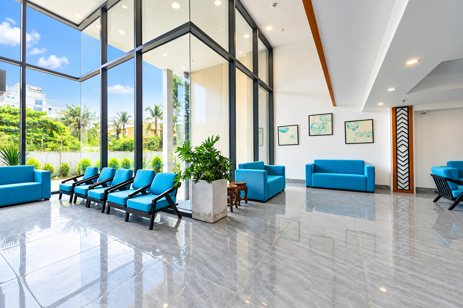 Blue lounge seating beside tall windows in the Nam Chau Stellar lobby